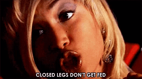 a close up of a woman 's face with the words `` closed legs don 't get fed '' written above her mouth .