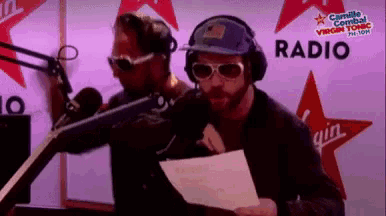 two men are standing in front of a radio sign