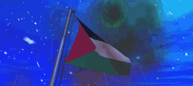 a flag is waving in the wind with a blue sky in the background
