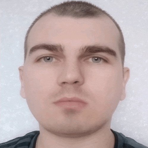 a close up of a man 's face with a black shirt on
