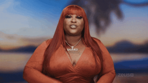 a woman with red hair wears a necklace that says baddies
