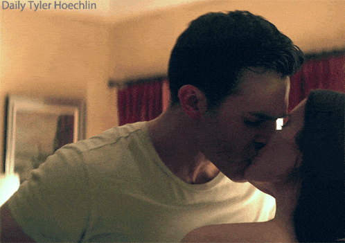 a picture of a man and woman kissing with the words daily tyler hoechlin behind them