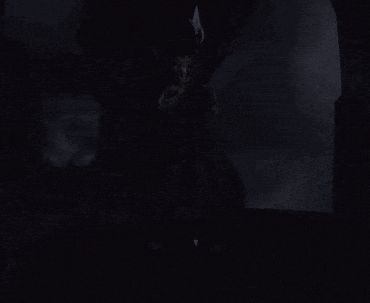 a dark room with a person standing in the middle