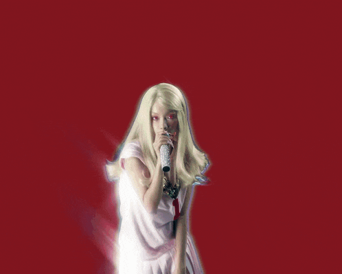 a blonde woman singing into a microphone on a cd