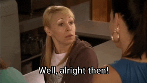a woman is talking to another woman and says well alright then .