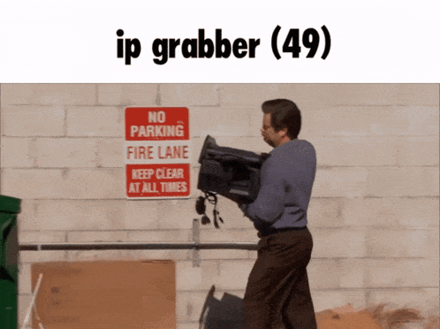 a man carrying a camera in front of a sign that says no parking fire lane keep clear at all times