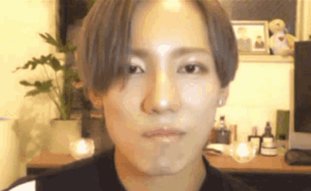 a close up of a young man making a funny face .