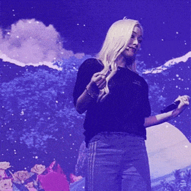 a woman holding a microphone in front of a blue background