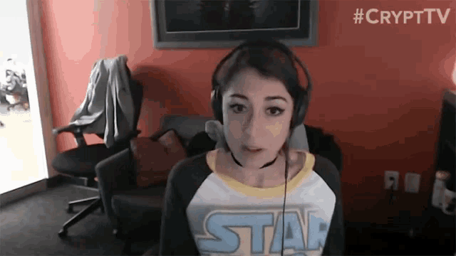 a girl wearing headphones and a shirt that says star on it