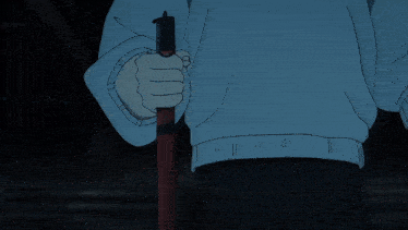 a man in a blue hoodie is standing in a dark room with his arms outstretched