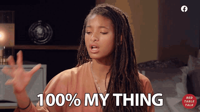 a woman says " 100 % my thing " in front of a red table talk logo