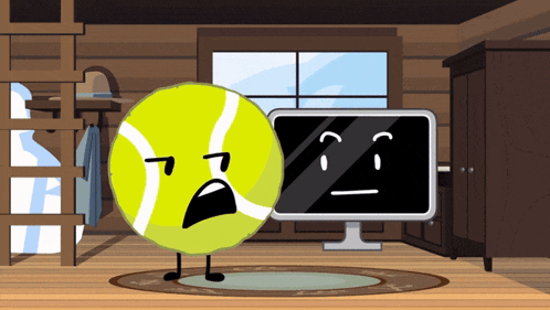 a tennis ball with a sad face stands next to a computer monitor