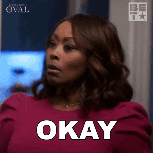 a woman in a pink shirt says " okay "