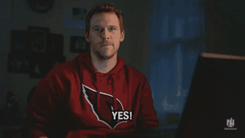 a man wearing a red cardinals sweatshirt says yes