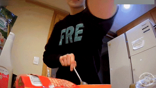 a person wearing a black shirt that says ' fre ' on it