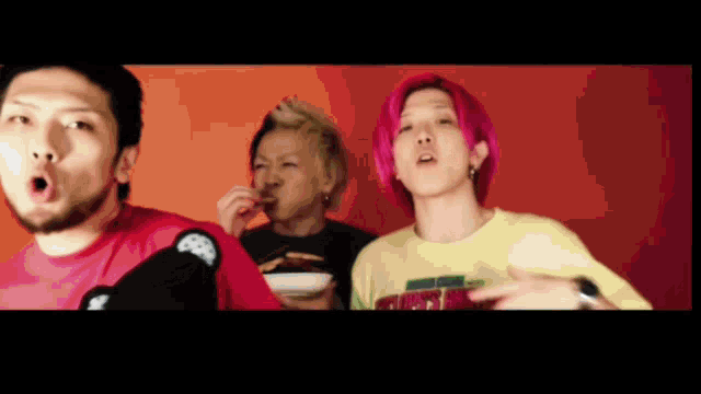 a man with pink hair is wearing a yellow shirt that says ' snoop dogg ' on it