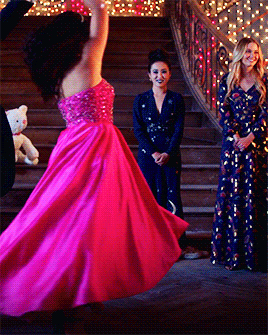 a woman in a pink dress is dancing on a stage