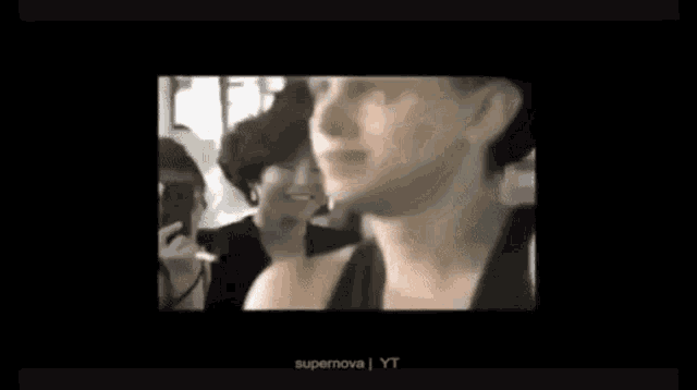 a black and white photo of a man in a crowd with the words supernova yt at the bottom