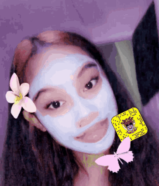 a girl wearing a face mask with a flower on her head