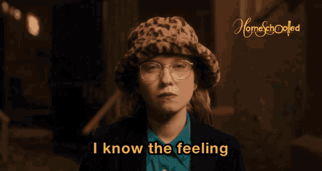 a woman in a leopard print hat and glasses says i know the feeling