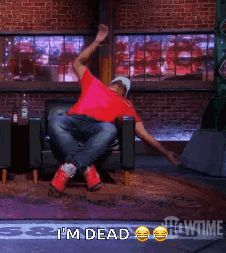 a man is laying on the floor with the words i 'm dead behind him