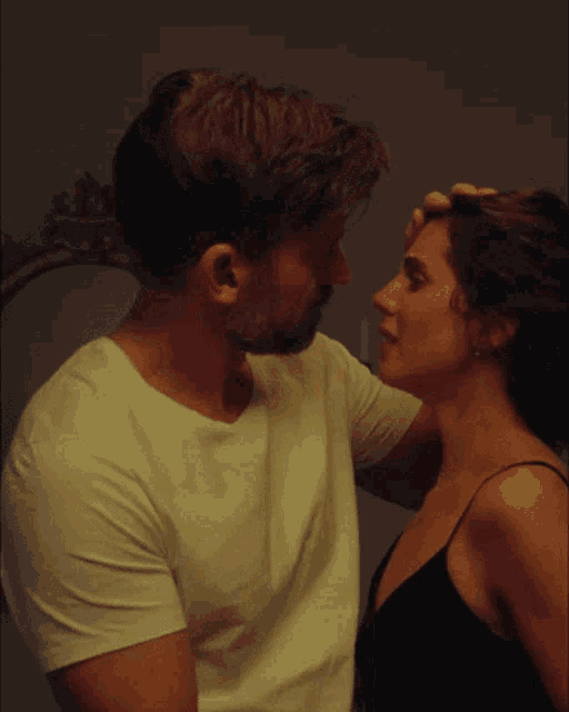 a man and woman are looking into each others eyes