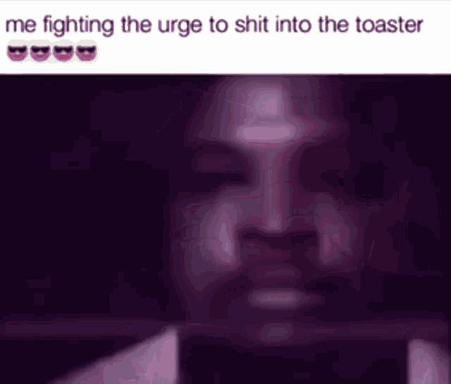 a man with a beard is fighting the urge to shit into the toaster