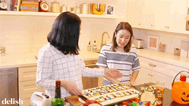 two women in a kitchen with the word delish on the bottom right corner