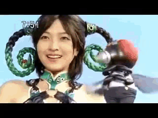 a woman is wearing a costume with a snake on her head and the time is 7:51 .