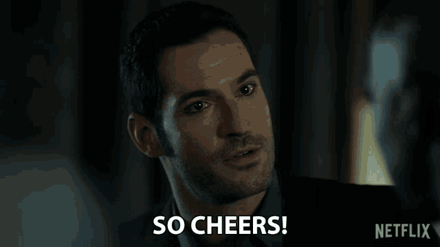 a man holding a glass with the words so cheers behind him