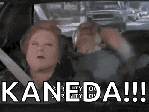 a woman is sitting in a car with the word kaneda written on it