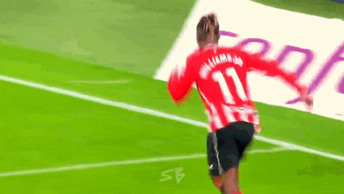 a soccer player with the number 11 on the back of his shirt