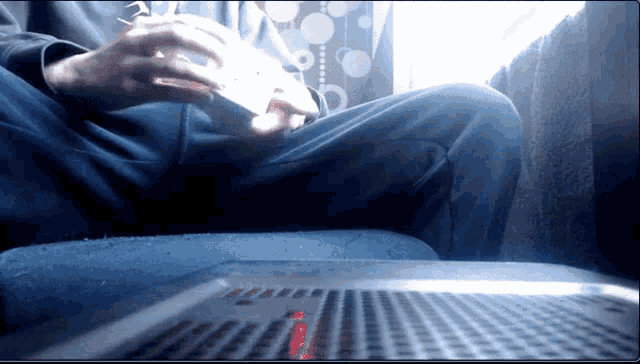a person is sitting on a couch playing a game