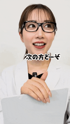 a woman wearing glasses and a white coat has a sticker on her face that says ' a ' on it
