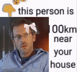 a man with glasses and a pink bow on his head is next to a sign that says this person is 100km near your house