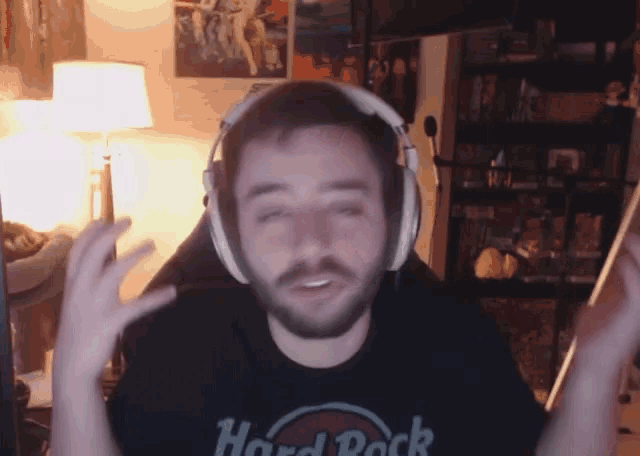 a man wearing headphones is wearing a hard rock t-shirt