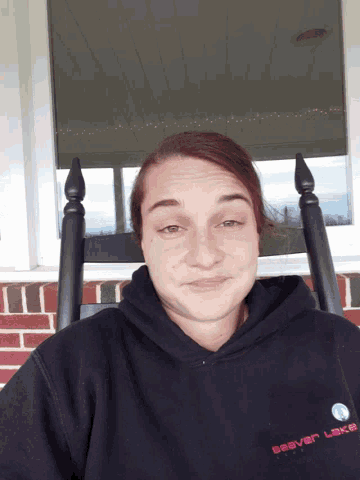 a woman wearing a sweatshirt that says river lakes on it