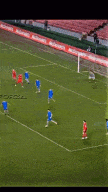 a soccer game is being played in a stadium with the word total on the side