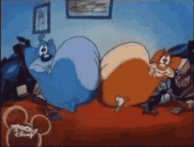 two cartoon characters are laying on a bed with a mickey mouse logo in the background