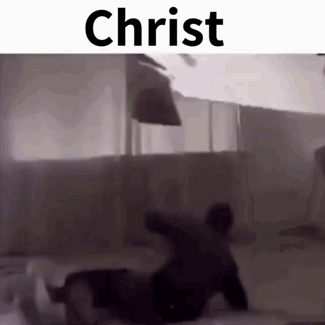 a black and white photo of a man laying on the floor under the word christ