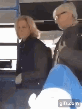a man and a woman are sitting on a bus with a gifs.com watermark