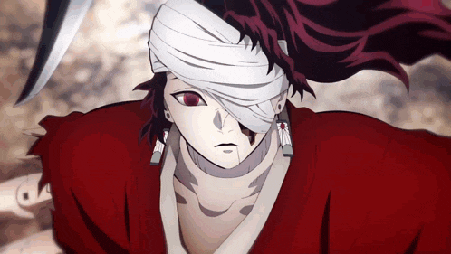 a man with a bandage on his head is holding a knife .