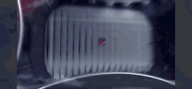 a blurred image of a device with a red and blue logo on it