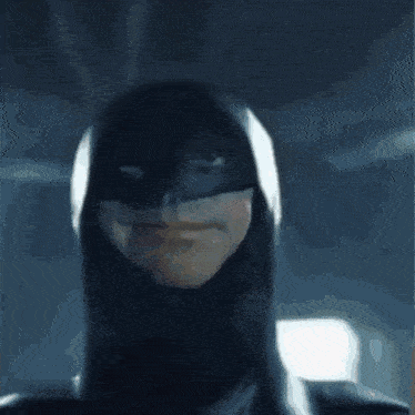 a close up of a person 's face in a batman costume