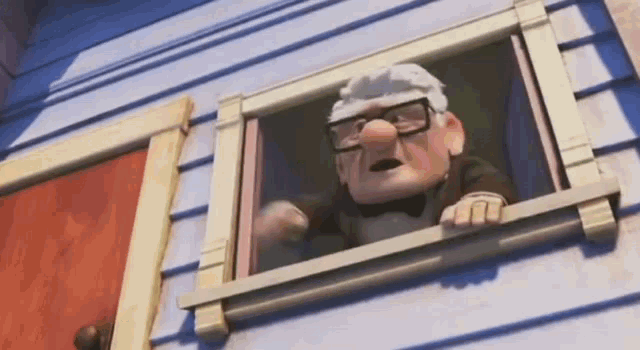 a cartoon character is looking out of a window in a house .
