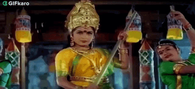 a woman in a yellow and green costume is holding a sword in her hands .