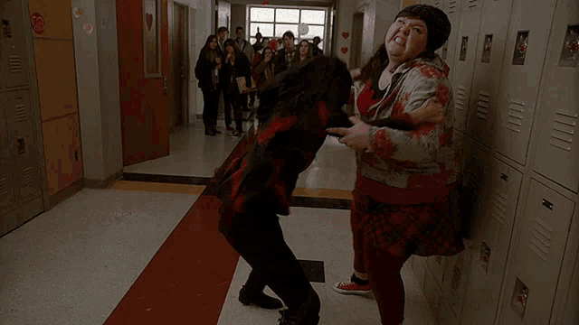 a girl in red converse shoes is standing in a hallway