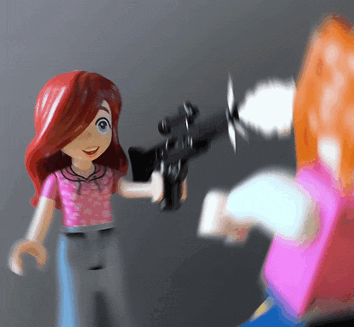 a girl with red hair is holding a gun in her hand