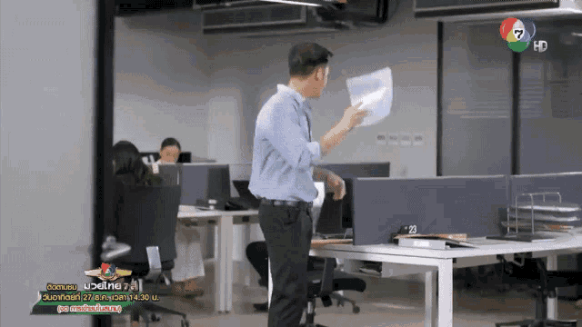 a man standing in front of a desk with a sign that says hd
