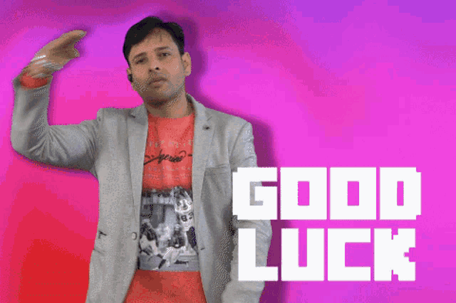 a man salutes in front of a purple background that says " good luck "